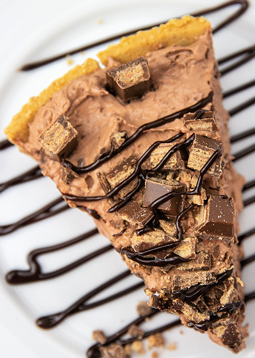 a slice of kit kat chocolate pie made with pudding on a white plate