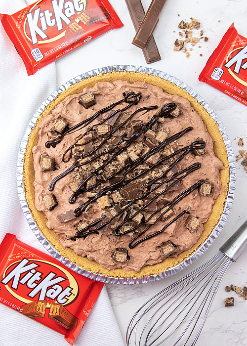 kit kat chocolate pie in a silver pie pan with candy bars arranged around it